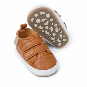 Detailed view of brown baby sneakers showing non-slip sole and soft leather texture