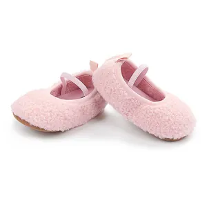 Side view detail of soft pink fleece baby walker shoes with elastic Mary Jane strap