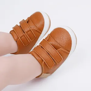 Soft brown faux leather baby walking shoes with double velcro straps for infants.