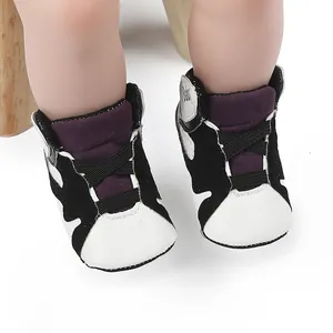 Macro view of black and white baby basketball shoes with soft anti-slip soles