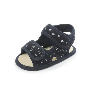 Navy blue baby walker sandal with white triangle patterns and adjustable velcro straps