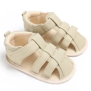 Detailed top view of breathable beige closed-toe baby sandals with soft non-slip soles