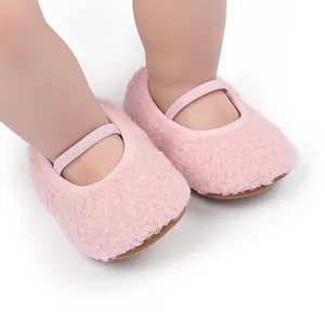 Detailed close-up showing texture of pink fuzzy fleece baby walking shoes with straps