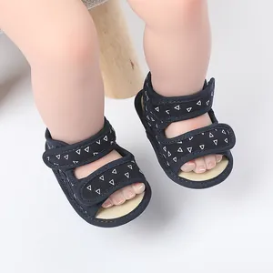 Detail of baby walking sandals with navy blue fabric and white triangle pattern