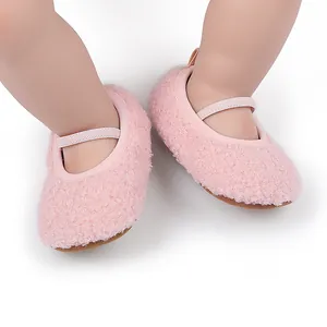 Detail showing soft fuzzy texture of pink baby walking shoes with elastic straps