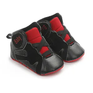Side angle view of black and red infant sneakers featuring a soft high-top design for safety