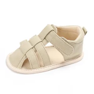 Detailed view of baby boy's closed-toe sandal with soft non-slip sole in beige.