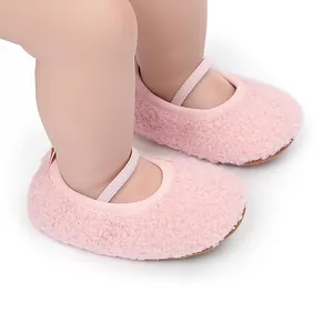 Close-up detail of soft pink sherpa fleece baby pre-walker shoes with elastic strap