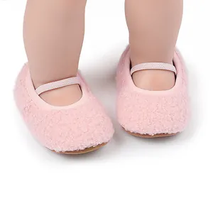 Detailed close-up of soft pink fuzzy infant pre-walker shoes with an elastic strap design