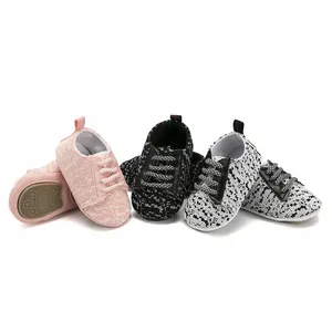 Close-up detail of multi-colored infant walking sneakers with anti-slip rubber soles