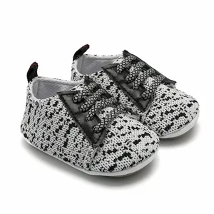 Close-up of knit baby walking shoes with zebra pattern and non-slip rubber soles
