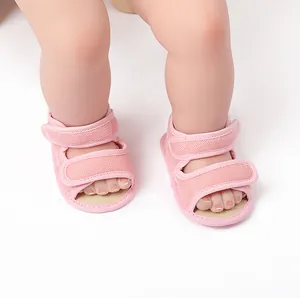 Close-up of lightweight pink mesh baby sandals with adjustable Velcro straps on soft feet