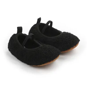 Macro view of black fuzzy sherpa baby walking shoes with elastic strap and soft sole
