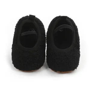 Soft black fuzzy plush infant pre-walker shoes featuring an elastic stay-on strap