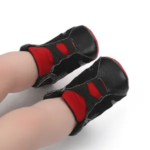 Detail view of black and red baby basketball shoes with soft non-slip soles