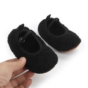 Detailed macro view of soft black sherpa baby pre-walker shoes with elastic strap