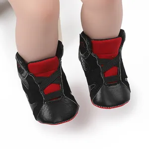 Detail view of black and red baby basketball pre-walker shoes with soft anti-slip soles