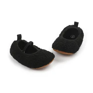 Macro view of black fuzzy toddler walking shoes featuring a comfortable elastic strap