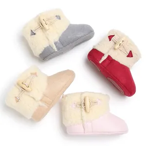 Detail view of colorful baby snow boots with warm fleece lining and toggle closure