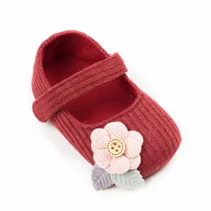 Adorable red knit baby princess shoes with soft soles and pink fabric flower ornament