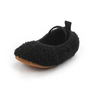 Close-up detail of black fuzzy fleece baby Mary Jane walking shoes with soft sole