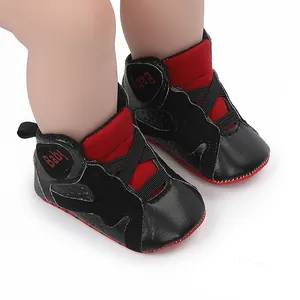 Close-up detail of black and red baby basketball shoes featuring soft and non-slip soles