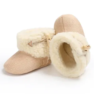 Close-up of baby snow boots with soft fleece lining and wooden toggle button closure.