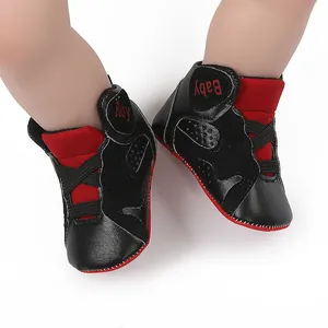 Detail shot of black and red infant basketball sneakers with soft non-slip soles