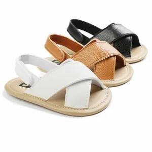 Close-up detail of soft-sole baby walker sandals with cross-strap design in multiple colors