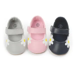 Detailed view of baby walking shoes in gray pink and navy featuring daisy flower prints