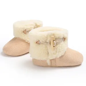 Cozy beige infant snow boots featuring soft fleece lining and wooden toggle button detail.