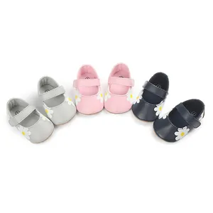 Close-up detail of three pairs of baby walking shoes with cute daisy flower prints