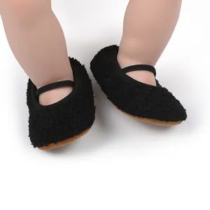 Soft black fuzzy fleece baby walking shoes featuring an elastic strap for comfort