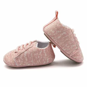 Close-up detail of pink knit baby walking shoes featuring a non-slip rubber sole