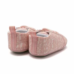 Detailed view of the soft pink knit fabric and heel loop on baby walking shoes