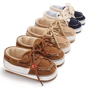 Nahaufnahme von Baby-Mokassins mit weicher Sohle in Braun-, Beige- und Blautönen