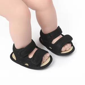 Close-up detail of black breathable mesh baby walking sandals with adjustable velcro straps