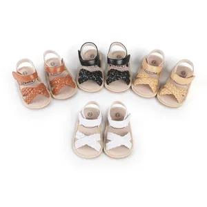 Detailed view of woven baby girl sandals in four colors: brown, black, tan, and white.