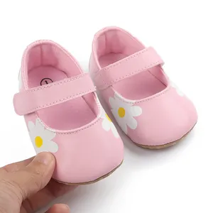 Detailed view of pink baby walking shoes featuring a cute white daisy pattern and strap