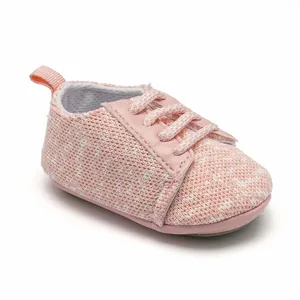 Close-up of a soft pink knitted baby sneaker featuring breathable fabric and decorative laces