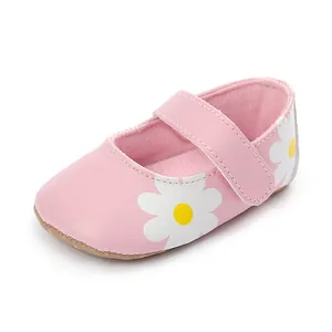 Comfortable pink baby walking shoes featuring white daisy prints and soft Velcro strap.