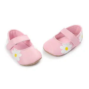 Close-up detail of pink baby pre-walker shoes featuring a white daisy flower print