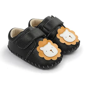 Vue détaillée des chaussures de marche bébé noires avec un motif de lion mignon