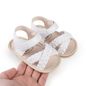 Detailed macro view of white braided summer sandals for newborn baby girls walking shoes