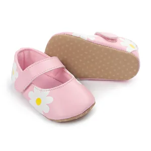 Pink baby walking shoes with white daisy pattern and non-slip sole detail
