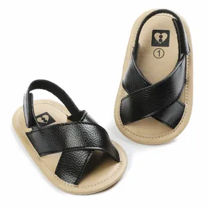 Close-up of black and tan baby summer sandals with soft non-slip soles
