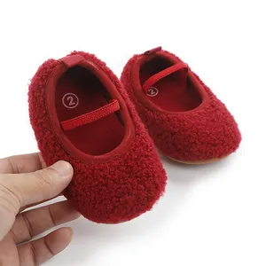 Detailed view of red fuzzy baby walking shoes featuring an elastic strap and soft textured fabric