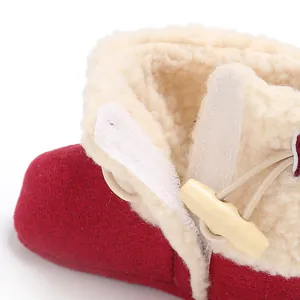 Close-up view of warm baby winter snow boot with soft faux fur lining and toggle button