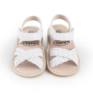 Detailed view of white braided baby sandals for summer newborn walker shoes.