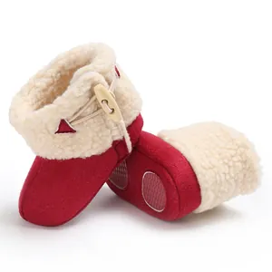 Detail of red baby snow boots with anti-slip rubber sole and warm faux fur lining